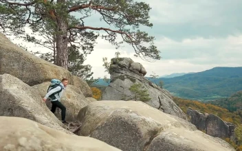 Stock Video Backpackers In Jeans Look Out Over Rustic Mountains For PC