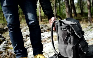 Stock Video Backpacker Walks Across Rocky Forest Towards River For PC