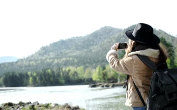 Stock Video Backpacker Takes Panoramic Photo Of River And Mountains For PC