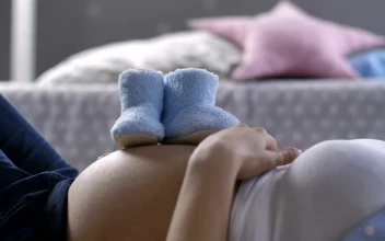 Stock Video Baby Shoes On A Womans Pregnant Belly For PC