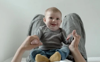 Stock Video Baby On The Belly Of His Mother Plays And Smiles For PC