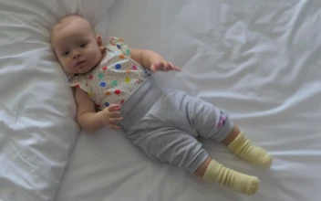 Stock Video Baby Girl Moving Around On A Bed For PC