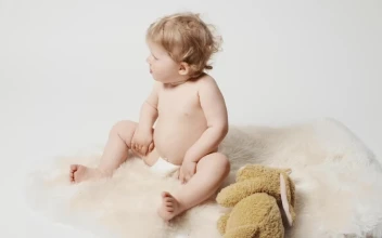 Stock Video Baby Blonde Girl With Plushie Eating A Snack For PC