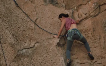 Stock Video Athletic Female Mountaineer Climbing A Rocky Mountain For PC