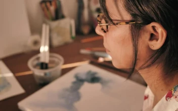Stock Video Artist Soaking Her Paintbrush To Paint With Watercolors For PC