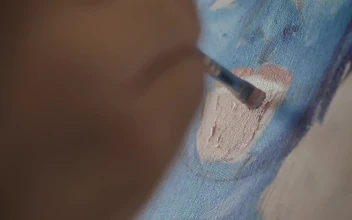 Stock Video Artist Painting The Mouth Of A Face On A Canvas For PC