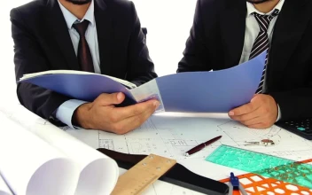Stock Video Architects In Suit Reviewing Papers In A Folder For PC