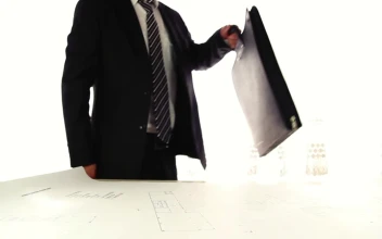 Stock Video Architect In A Suit Taking Out His Instruments For PC