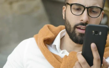 Stock Video Arab Man Smiles While Using Mobile App For PC