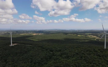Stock Video Approaching A Wind Turbine From Above For PC