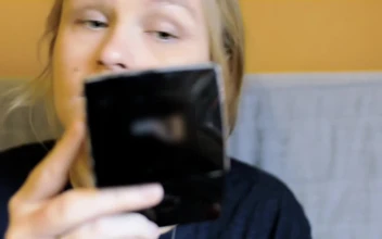 Stock Video Applying Makeup Using A Small Mirror For PC