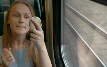 Stock Video Applying Makeup On A Train For PC