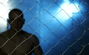 Stock Video Angry Shirtless Man Behind Wire Fence For PC