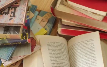 Stock Video All Kinds Of Books Stacked On A Table Seen Up For PC