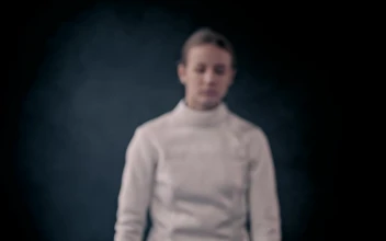 Stock Video A Young Woman Fencer Posing With Her Sword For PC