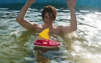 Stock Video A Young Man In The Pool With A Toy Boat For PC