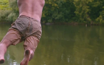 Stock Video A Young Man On A Swing And Dives Into The For PC