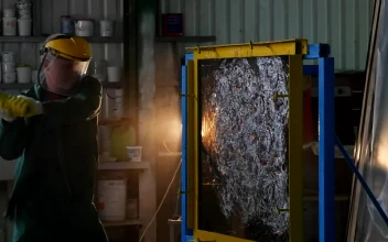 Stock Video A Worker With Protective Uniform Hitting A Glass Sheet For PC