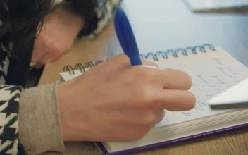 Stock Video A Woman Writing In Her Spiral Notebook For PC