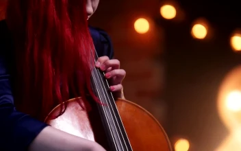 Stock Video A Woman With Red Hair Plays The Cello For PC