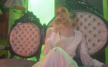 Stock Video A Woman Sitting In A Vintage Couch Looks Into The For PC