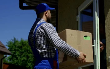 Stock Video A Woman Receives A Package From The Delivery Guy For PC