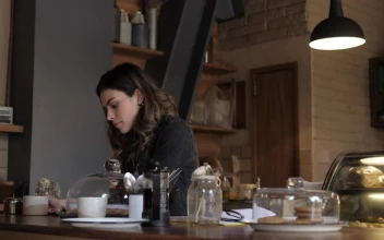 Stock Video A Woman Reading A Book At A Coffee Shop For PC