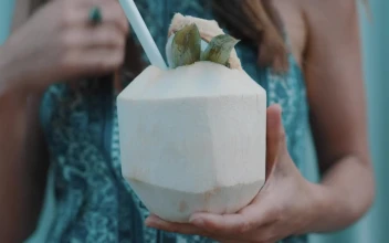 Stock Video A Woman Drinking Coconut Water With A Straw For PC