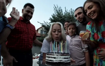 Stock Video A Woman Blows The Candles In A Birthday Party For PC