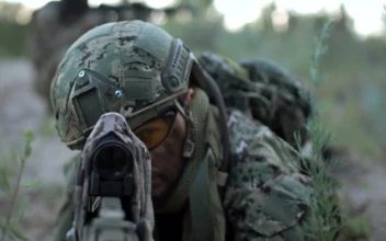 Stock Video A Sniper Laying On The Ground Is Aiming For PC