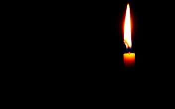 Stock Video A Single Candle Burning In The Dark For PC