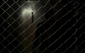 Stock Video A Shirtless Man Behind A Wire Fence For PC
