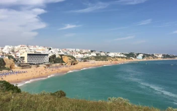 Stock Video A Sandy Beach With A White City For PC