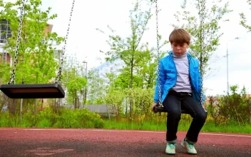 Stock Video A Sad Boy Sitting On The Swings For PC
