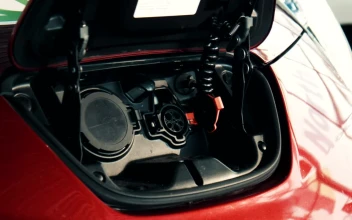 Stock Video A Red Electric Car Being Charged For PC