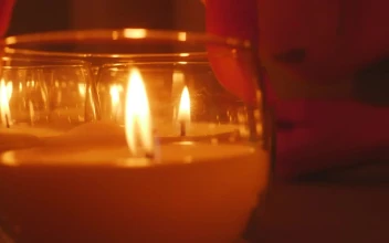 Stock Video A Persons Hand Accommodating Small Candles For PC