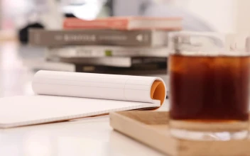 Stock Video A Person Writing On A Notebook At A Coffee Shop For PC