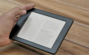 Stock Video A Person Reading An Ebook While Drinks Coffee For PC