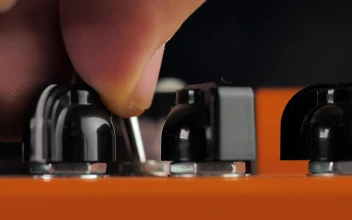 Stock Video A Person Adjusting The Levels Of Some Distortion Pedals For PC
