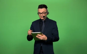 Stock Video A Newscaster With Tablet And Headset For PC