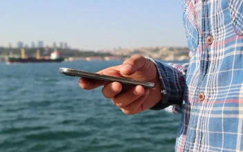 Stock Video A Mans Hand Holding A Cell On A Boat For PC
