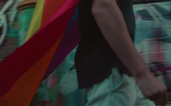 Stock Video A Man With A Rainbow Flag Walking In The Street For PC