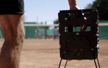 Stock Video A Man Takes A Tennis Ball Out Of The Basket For PC