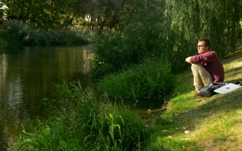 Stock Video A Man Sitting On The Riverside Thinking For PC