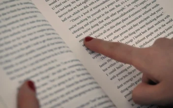 Stock Video A Girls Hand With A Book Following The Reading With For PC
