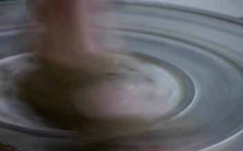 Stock Video A Foot Is Rotating Ceramic Wheel For PC