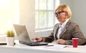 Stock Video Business Leader Works On Laptop And Sips Drink For PC