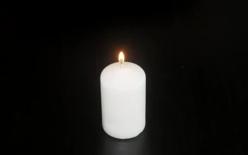Stock Video Burning Candle Against A Dark Background For PC