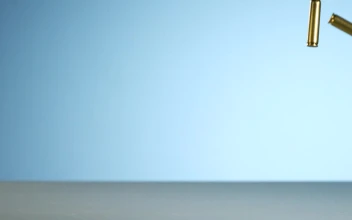 Stock Video Bullets Falling And Bouncing On A Blue Background For PC