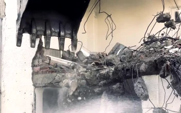 Stock Video Bulldozer Knocking Down The Structure Of A Ruined Building For PC